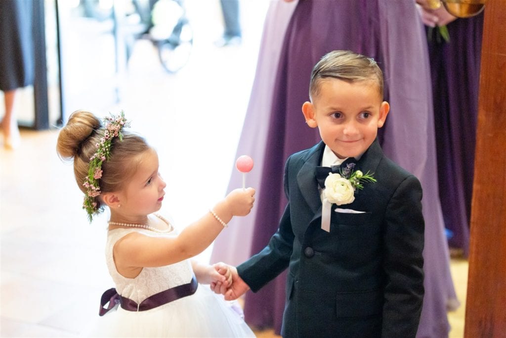 Adorable photo of the flower girl and ring boy standing near each other at The Conrad Fort Lauderdale Beach, wedding planned by Oh My Occasions