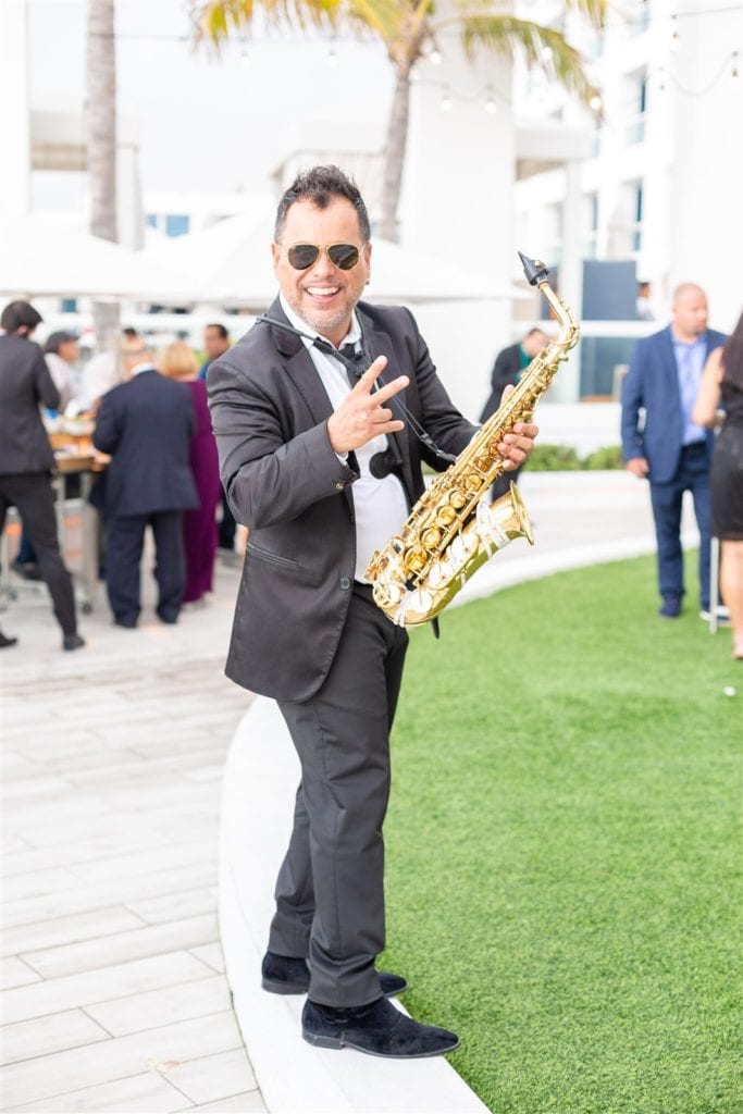 The saxophone player outdoors on the lawn at The Conrad Fort Lauderdale Beach, wedding planned by Oh My Occasions