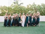 tropical wedding at Miami Beach Edition wedding with emerald green bridesmaids dresses walking on the terrace