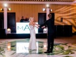 bride and groom dance on the palm leaf dance floor at miami beach edition