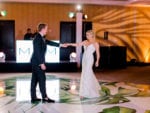 bride and groom dance on the palm leaf dance floor at miami beach edition