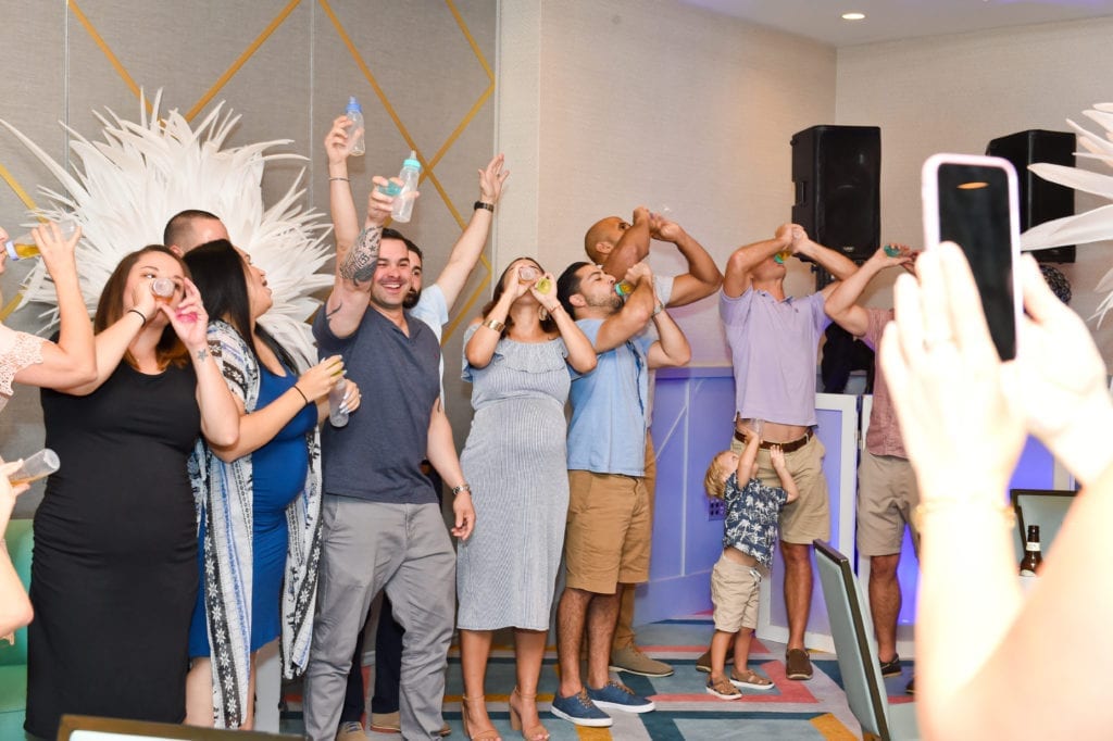 a fun baby shower game where guests chug bottles of apple juice the quickest