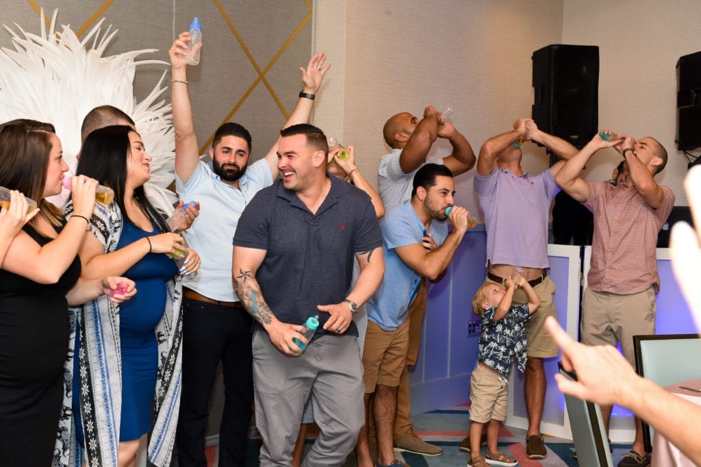 A bottle chugging baby shower game where everyone participated