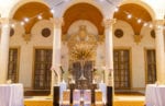 mirror pedestal seating chart for escort cards with bistro lighting, pampas grass centerpiece at Biltmore miami wedding terrace