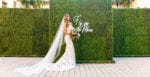 bride in front of a hedge wall wearing a berta bridal gown