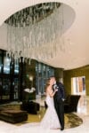 bride and groom laugh in the lobby of JW Marriott Marquis Miami