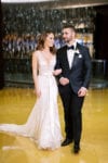bride and groom walk arm in arm at JW Marriott Marquis Miami wedding