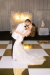 metallic gold and white checkerboard dance floor with feather wall and neon sign at JW Marriott Marquis Miami wedding designed by Oh My Occasions, a naples and tampa wedding planner