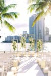 beach ceremony with orchids and velati candles at mandarin oriental miami wedding