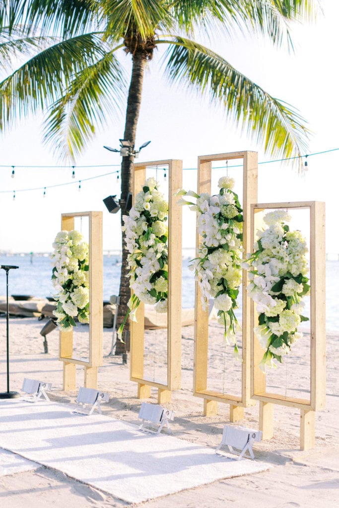 Side profile view of the gold acrylic rectangular arch with orchids and hydrangea arrangement hanging at The Mandarin Oriental, wedding planned by Oh My Occasions