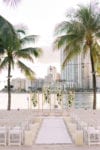 mandarin oriental miami wedding beach ceremony with orchids and bistro lighting with white carpet