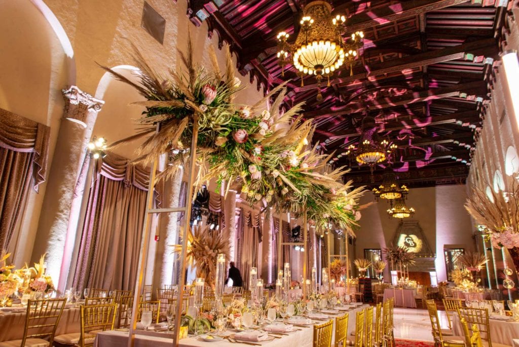 Floral installation above rectangle reception table at The Baltimore Hotel in Miami Coral Gables, wedding planned by Oh My Occasions