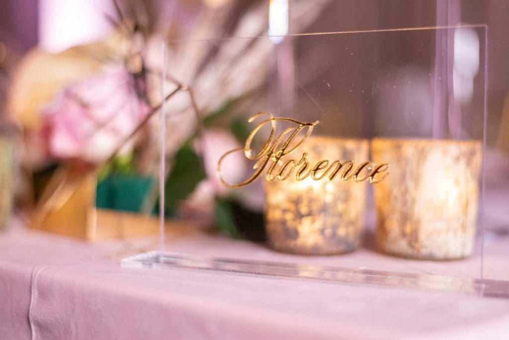 Place card with name is cursive gold.
