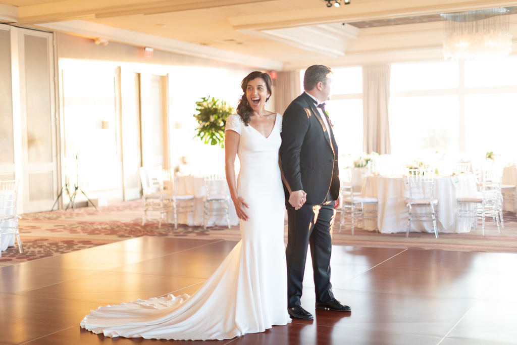 The bride and groom's reaction to the wedding venue at The Rusty Pelican, planned by Oh My Occasions