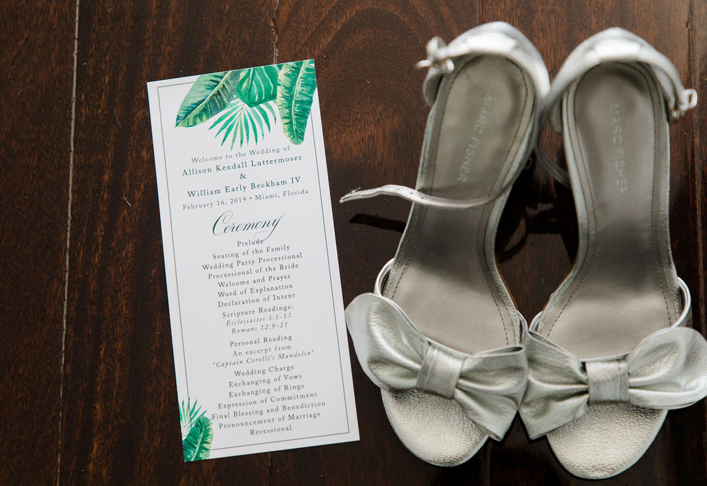 Ceremony program with the bride's silver heels