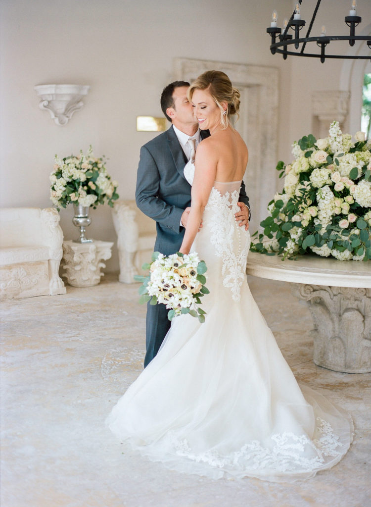 Groom kisses bride for their first looks at the Fisher Island Club.