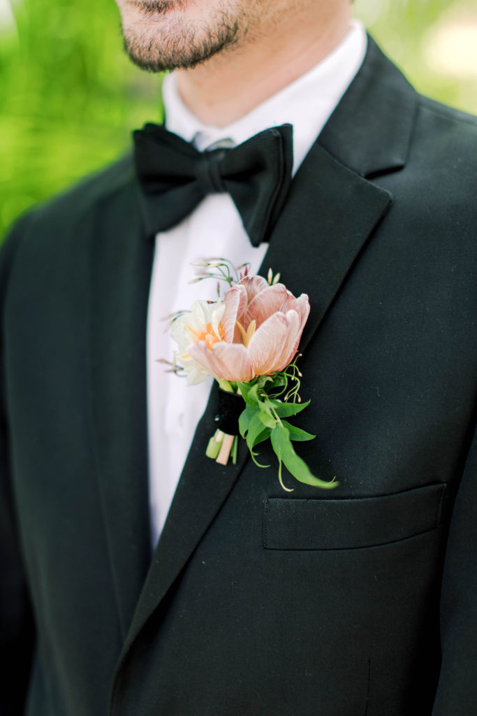 A closeup of the groom's boutonniere at Villa Woodbine in Coconut Grove, wedding planned by Oh My Occasions