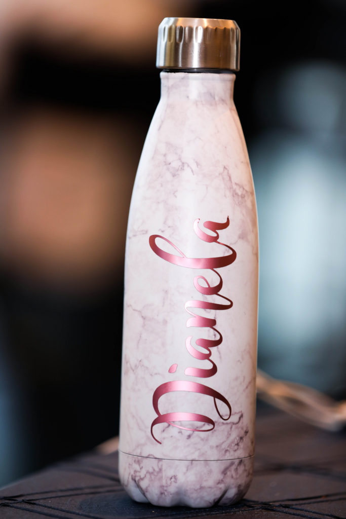 Custom name water bottle in fuchsia pink with a marble background at the Kimpton EPIC Hotel, planned by Oh My Occasions