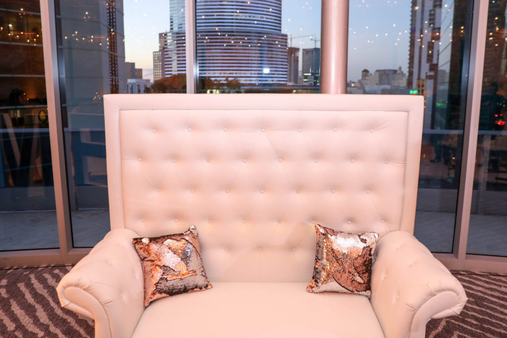 White lounge chairs with gold sequence pillows at the Kimpton EPIC Hotel, planned by Oh My Occasions