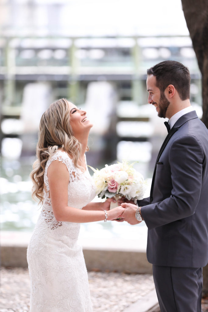 The bride and groom's first look outdoors at the Kimpton EPIC Hotel, planned by Oh My Occasions