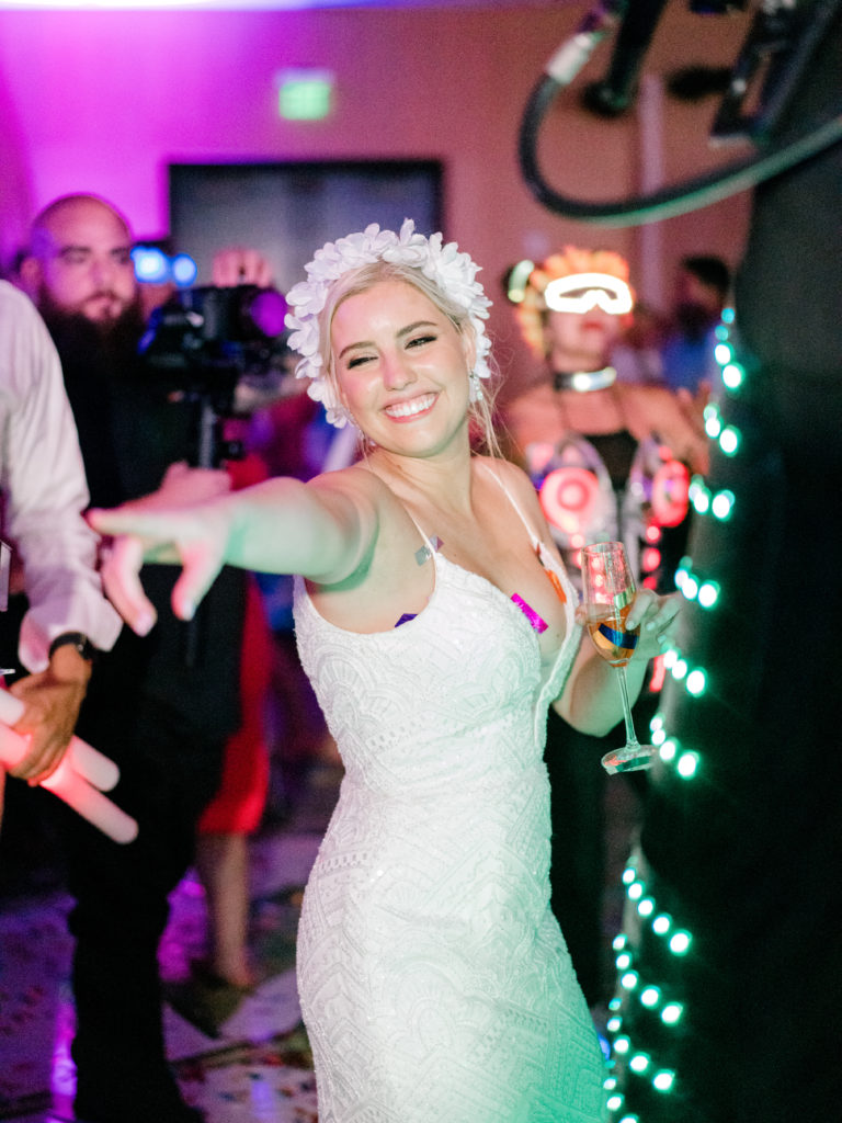 The bride dancing on the dance floor with her floral crown at Miami Beach Edition, planned by Oh My Occasions