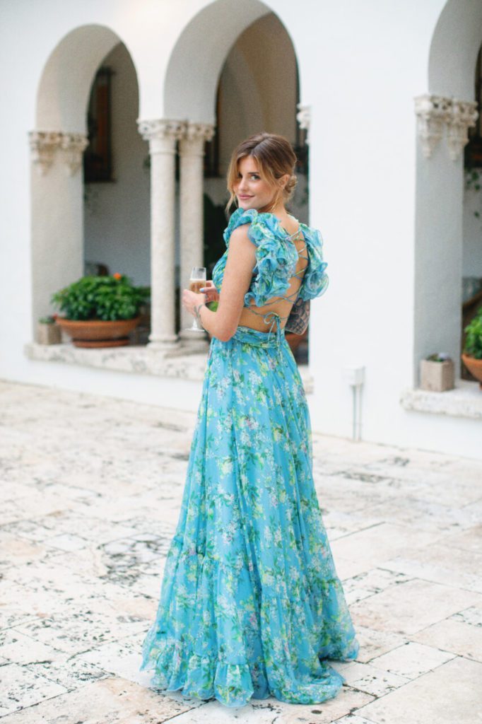 A beautiful wedding guest in a long blue aqua maxi dress, perfect for a Miami wedding outdoor at Indian Creek Country Club planned 