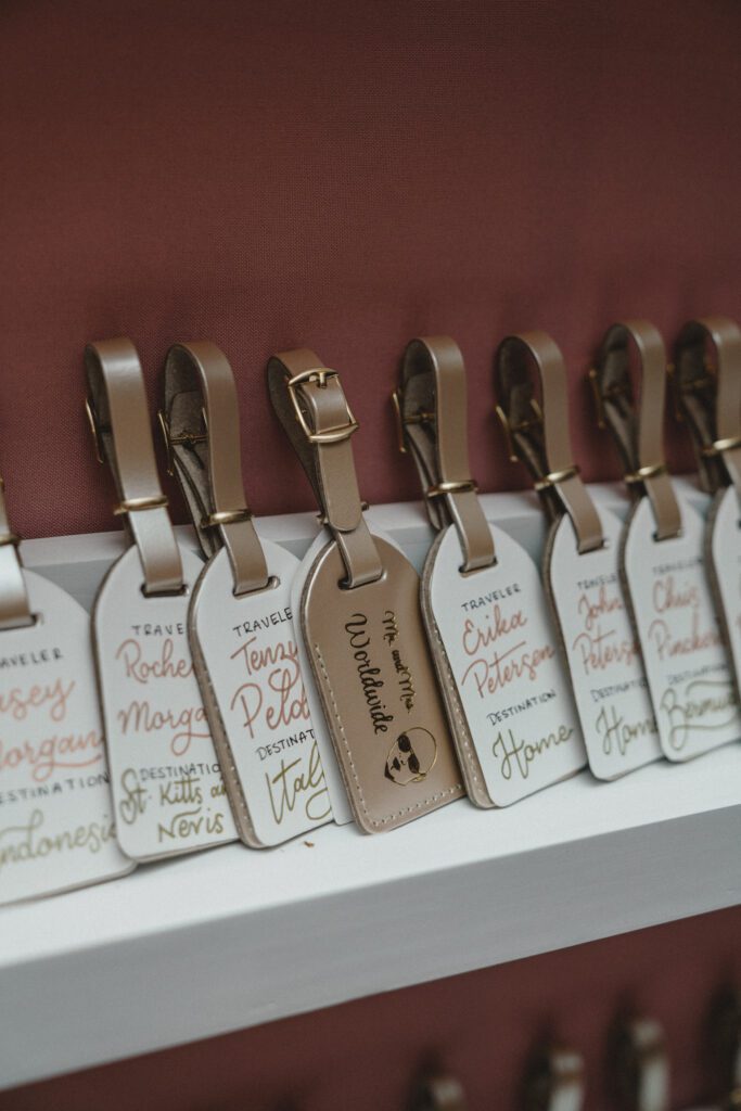 Champagne gold and white luggage tag place cards at Club of Knights wedding planned and designed by Oh My Occasions
