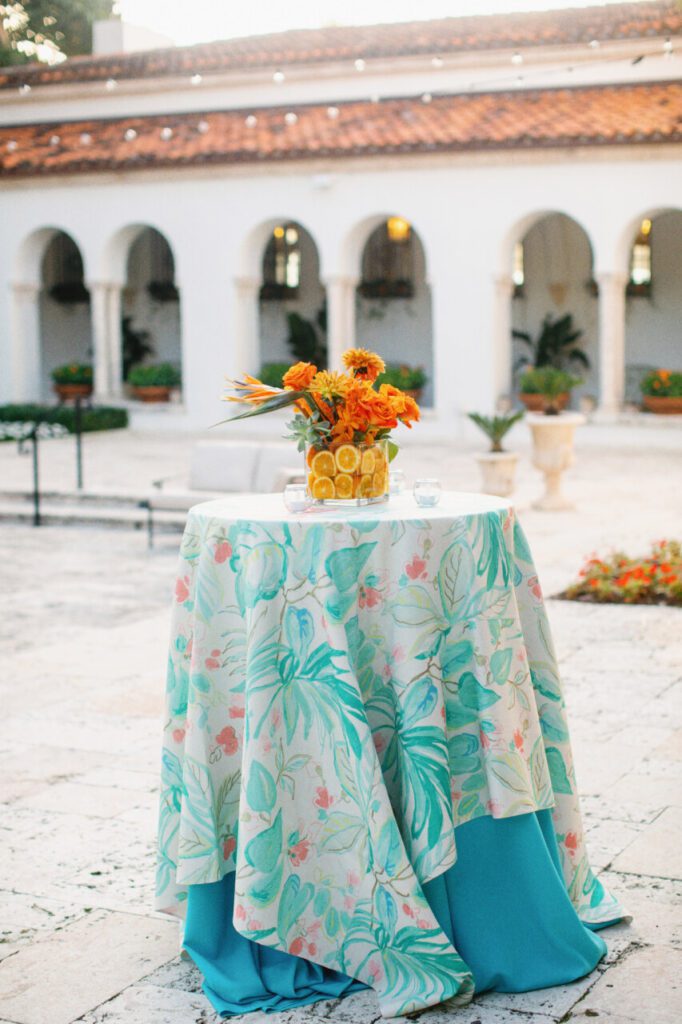 The outdoor cocktail hour theme perfectly aligned with the wedding location... Miami! Bringing the sliced fruit and colorful decor colors outside! At  Indian Creek Country Club planned by Oh My Occasions.