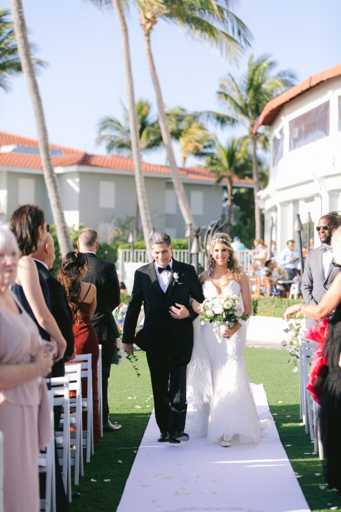 a bride walks down the aisle at La Playa Golf and Beach Resort in Naples Florida