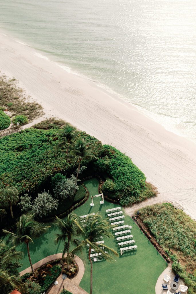 a bird's eye view of a ceremony setup along the beach at La Playa Golf and Beach Resort in Naples Florida