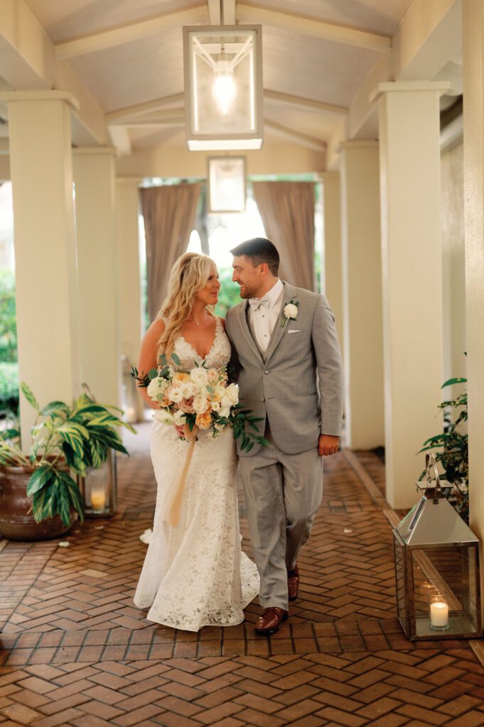 a bride and groom have their first look in lantern lane at La Playa Golf and Beach Resort in Naples Florida